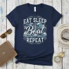 Eat Sleep Boat Repeat nautical design on a navy t-shirt featuring an anchor, sailboat, and waves