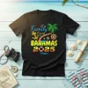 Family Cruise Bahamas 2025 text with palm tree, anchor, ship's wheel, and life preserver graphics on a black t-shirt