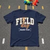 Navy t-shirt with "FIELD day ORANGE TEAM" text, featuring orange and white checkered lightning bolt graphic