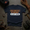 Navy t-shirt with "I'm In A Dark Place. Not Emotionally. I'm Just Caving." text in orange and white, designed for