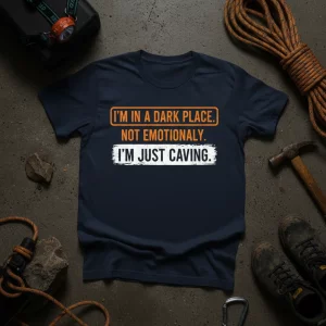 Navy t-shirt with "I'm In A Dark Place. Not Emotionally. I'm Just Caving." text in orange and white, designed for