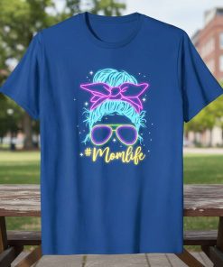 Neon #Momlife text with a messy bun and sunglasses graphic on a blue t-shirt